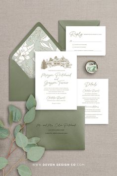 the wedding stationery is displayed with greenery and foliage, including an elegant green envelope