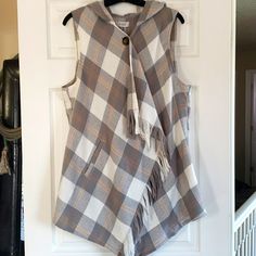 a plaid vest hanging on a white door