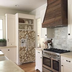 a kitchen with an oven, stove and refrigerator in it's center island area