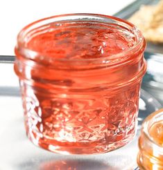 a glass jar filled with honey sitting on top of a table next to other items