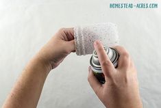 a person is holding a can and cleaning it