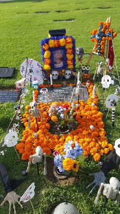 an arrangement of flowers and skeletons on the grass