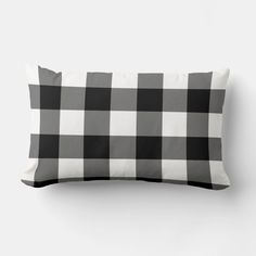 a black and white checkered pillow on a wall