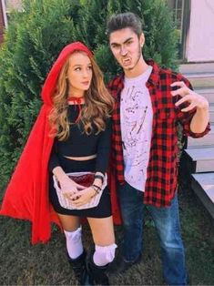 a man and woman dressed up in costumes posing for a photo outside on the grass