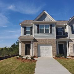 a two story house with white trim and brown shutters on the front door is shown