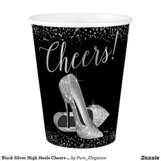 a black and white paper cup with high heel shoes on the front, cheers written in silver glitter