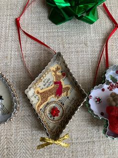 three christmas ornaments are sitting on a table