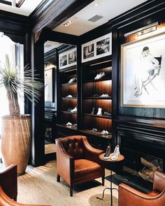 a living room filled with lots of furniture and bookshelves