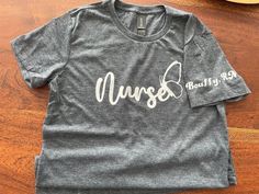 Nurse T-Shirt, shortsleeve, 100% Cotton high quality Gildan T-Shirt, fitted soft-style. Customizable with your name on the sleeve if desired.  Sizes S-XL available. PM me for color options. Fitted Short Sleeve T-shirt With Custom Print, Gray Short Sleeve T-shirt With Letter Print, Fitted Crew Neck T-shirt With Custom Print, Fitted Short Sleeve T-shirt With Letter Print, Fitted Basic Pre-shrunk T-shirt, Fitted Crew Neck Pre-shrunk T-shirt, Fitted Gray Graphic Tee, Gray Fitted Crew Neck T-shirt, Fitted Basic T-shirt With Name Print