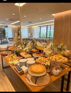 a buffet table filled with lots of different types of foods and desserts on top of it