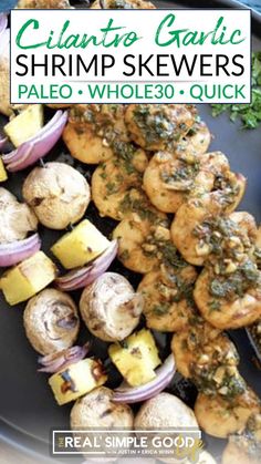 grilled shrimp skewers on a plate with onions and parsley