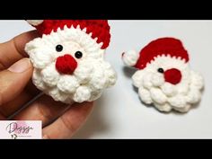 two crocheted santa claus ornaments are shown in the palm of someone's hand