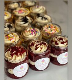 several jars filled with desserts sitting on top of a table