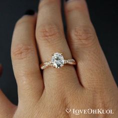 a woman's hand with a diamond ring on her finger and an engagement band