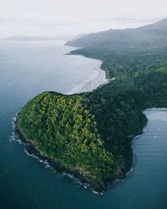 an island in the middle of water surrounded by trees