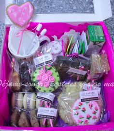 a pink box filled with lots of treats