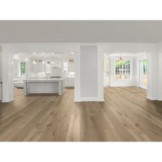 an empty living room with wood floors and white walls