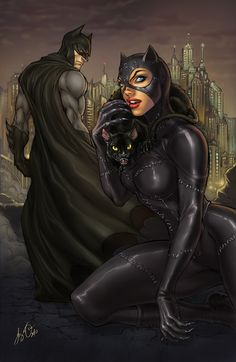 a woman in black catsuit holding a cat next to a man wearing a batman mask