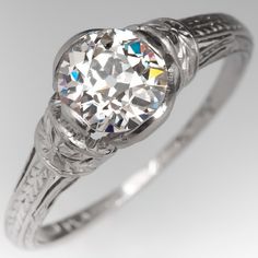 an antique style diamond engagement ring with filigrees