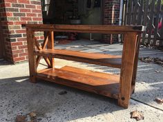 a wooden table sitting on top of a sidewalk