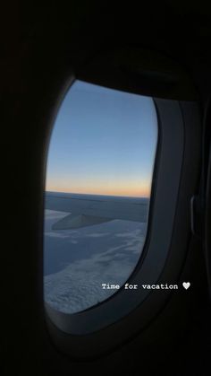 an airplane window looking out at the ocean