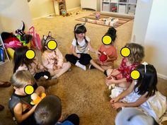 a group of children sitting on the floor in a circle with yellow circles around them