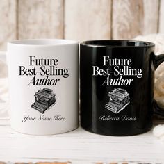 two black and white coffee mugs sitting next to each other on top of a table