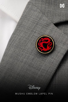 a close up of a person wearing a suit and tie with a pin on it