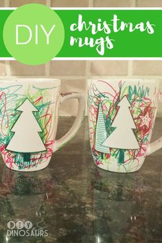 two coffee mugs with christmas trees painted on them and the words diy christmas mugs