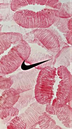 a pink and white background with the word nike written in black on top of it