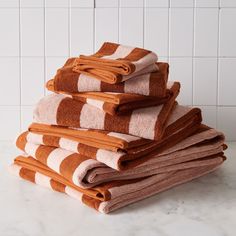 a stack of towels sitting on top of a white counter