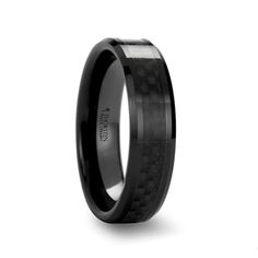 black ceramic ring with carbon fiber inlays and anodic center, on a white background