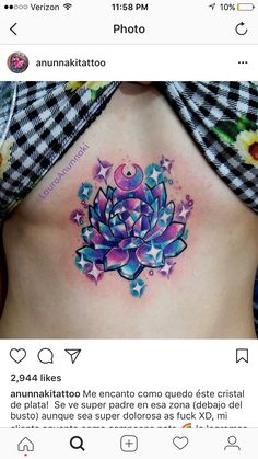 a woman's stomach with a colorful flower tattoo on her belly and stars around it