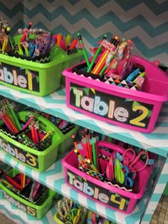 several bins with pens and pencils in them are on display at the store