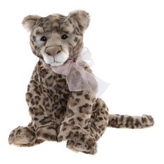 a stuffed leopard with a bow around its neck sitting on a white background and looking at the camera