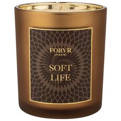 a candle that is brown and gold with the words soro soke on it