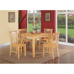 a dining room table and chairs with red walls