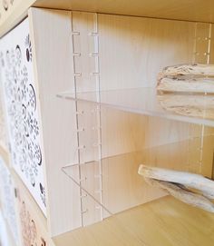 the shelves are made out of wood and have clear acrylic paint on them