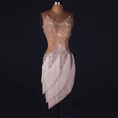 a mannequin wearing a dress with fringes on it's chest and back