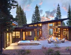 a large house with a hot tub in the middle of it's patio area