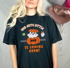 "Our cute little Pumpkin BOO Coming Soon Unisex Comfort Colors garment-dyed heavyweight t-shirt, gender reveal shirt, Pregnancy announcement tee shirt, fall Autumn baby announcement shirt. Introducing the perfect blend of style and charm, our Comfort Colors 1717 T-shirt brings forth a delightful Halloweenish design that will warm hearts and raise spirits. Celebrate the joyous anticipation of your little one's arrival with this endearing baby announcement and gender reveal tee, lovingly adorned w Cute Crew Neck T-shirt For Gender Reveal, Gender Reveal Relaxed Fit Graphic T-shirt, Fun Crew Neck T-shirt For Gender Reveal, Cute Funny Print T-shirt For Gender Reveal, Cute T-shirt With Funny Print For Gender Reveal, Cotton Maternity T-shirt For Gender Reveal, Maternity Shirts Vinyl Halloween, Halloween Shirt For Pregnant Women, Pumpkin Boo