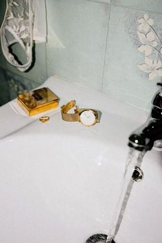 a bathroom sink with a faucet running water from it's spout