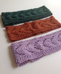 three crocheted headbands sitting on top of a table