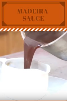 there is a sauce being poured into a white bowl on the table with an orange border around it