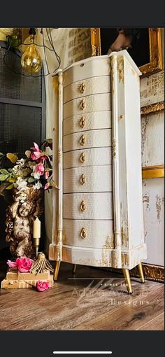 an old dresser is next to a vase with flowers