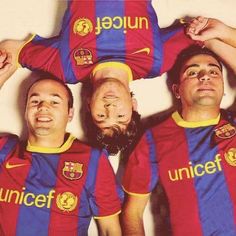 three soccer players are posing for a photo with their heads on top of each other