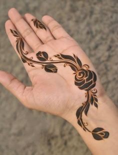 a person's hand with a henna tattoo on it