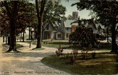 an old photo of a house in the middle of trees and grass with a walkway leading to it