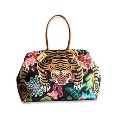 A fun floral cotton print with a Tiger placed perfectly to day hello! Opening with a 16" rectangular snap frame, the Atenti Pioneer carpet bag shows off a fully lined water resistant taffeta interior. Inside are a zippered pocket and an open divided pocket with a cell phone slot. The Pioneer has double 21” straps with a 10’ drop and metal feet. Made in United States Dimensions: 23 x 2 x 13 in Multicolor Floral Print Top Handle Bag, Floral Print Double Handle Travel Bag, Multicolor Rectangular Canvas Bag With Floral Print, Rectangular Travel Bag With Floral Print, Rectangular Floral Print Canvas Shoulder Bag, Rectangular Canvas Bags With Floral Print, Floral Print Top Handle Bag For Travel, Rectangular Travel Bags With Fabric Lining, Rectangular Travel Bag With Fabric Lining