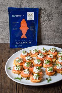 small appetizers on a plate next to a bag of salmon